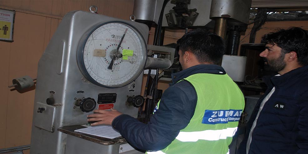 Engineers running a compression test in the lab