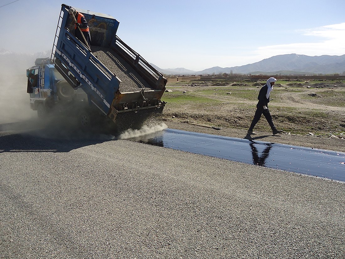 Zurmat truck placing base material on a new road